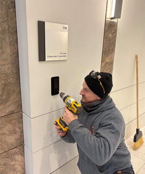 Access Control Systems - man installing device on wall